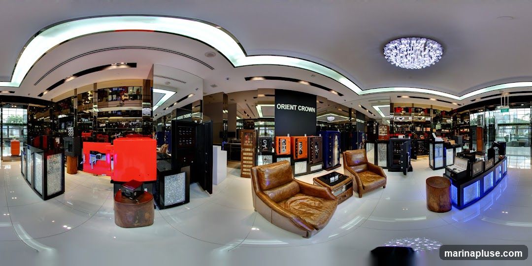 A panoramic view of the interior of a luxury watch store. The store features sleek displays, comfortable seating, and a prominent "ORIENT CROWN" sign. The displays showcase various watches and accessories, with some safes also visible. The lighting is modern and elegant, with a large chandelier adding to the ambiance.
