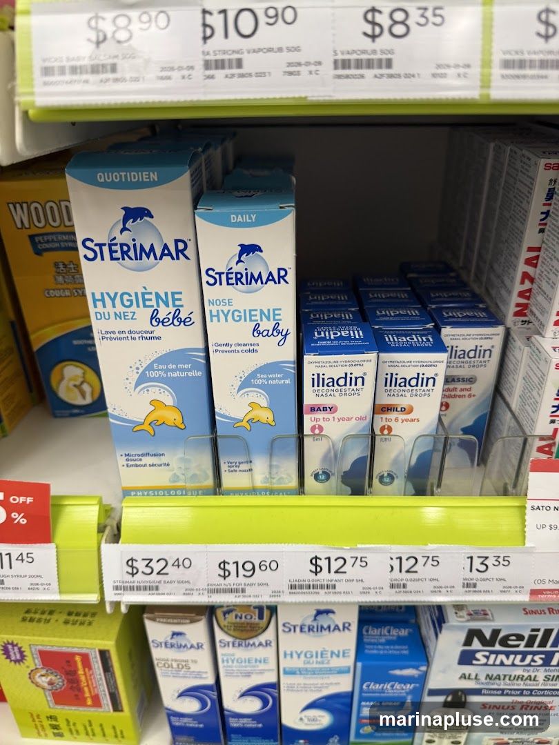 A shelf in a store displays various nasal hygiene products, including Sterimar baby nasal spray, Iliadin decongestant nasal drops, and other brands. Prices are visible above some of the products.