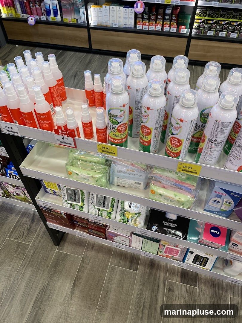 A retail display shelf stocked with various personal care items, including sanitizing sprays, face masks, and skincare products. The products are arranged on multiple shelves, with clear pricing visible for some items.