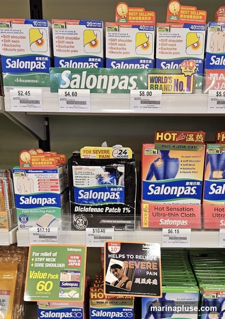 A shelf display of various Salonpas pain relief patches and related products. The products are arranged on multiple shelves, with some items in boxes and others in display packaging. Prominent branding and product names like 'Salonpas', 'Diclofenac Patch 1%', and 'Hot Sensation Ultra-thin Cloth' are visible. Pricing is displayed for several items, ranging from $2.45 to $17.10. Some packaging highlights features such as 'Singapore Best Selling', 'World's Brand No. 1', 'Made in Japan', and 'Apply for 24 Hours'. A promotional sign indicating 'Save 10% Helps to Relieve Severe Pain' is also present.