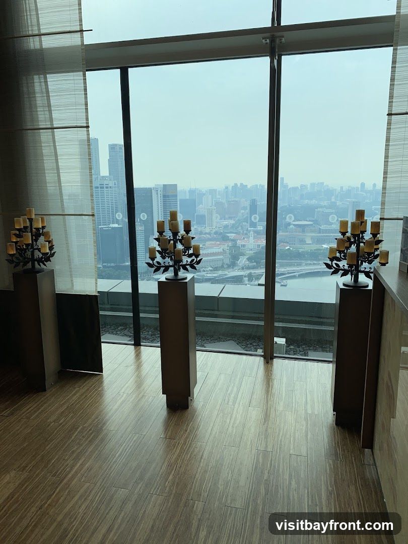 Three ornate candelabras stand on tall pedestals in front of a large window overlooking a sprawling cityscape. The floor is made of polished wooden planks. The candelabras have multiple candle holders, and the overall scene suggests an elegant interior space with a panoramic view.