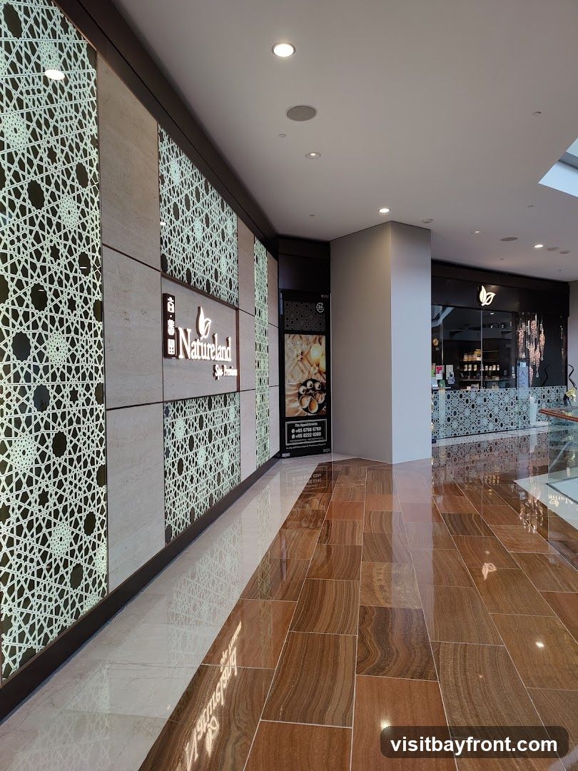 A spa with a modern and elegant interior. The walls are decorated with intricate geometric patterns and the floor is made of polished wood-like tiles. A sign with the spa's logo and name,