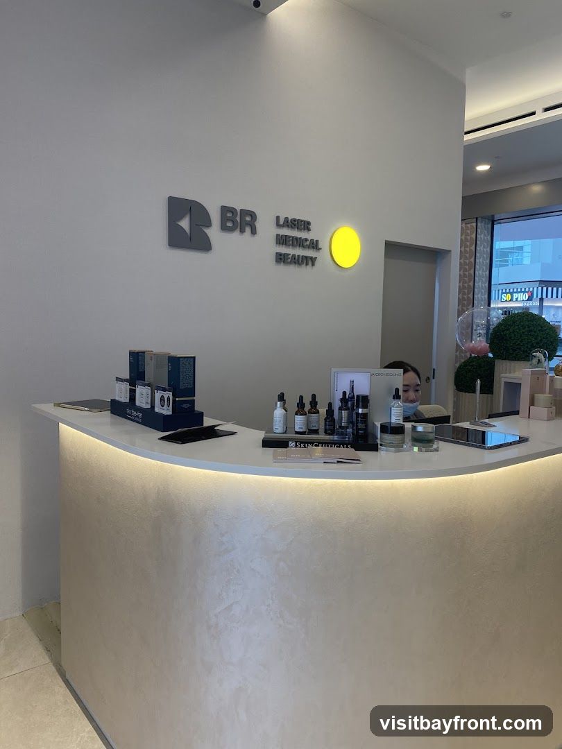 A reception desk with products displayed on top. The logo "BR LASER MEDICAL BEAUTY" is visible on the wall behind the desk. A person is partially visible behind the desk.
