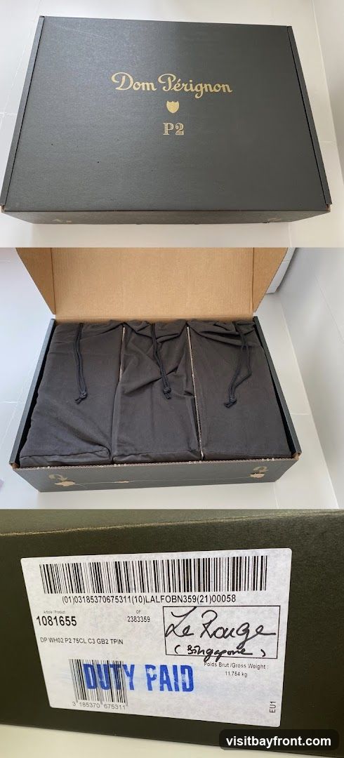 A dark green gift box for Dom Pérignon P2 champagne. The lid is closed and features the Dom Pérignon logo and "P2" in gold lettering. The box is open in the second image, revealing three dark cloth bags inside, presumably containing bottles. The third image shows a label on the side of the box with product information, a handwritten note "Le Rouge (Singapore)", and a "DUTY PAID" stamp.