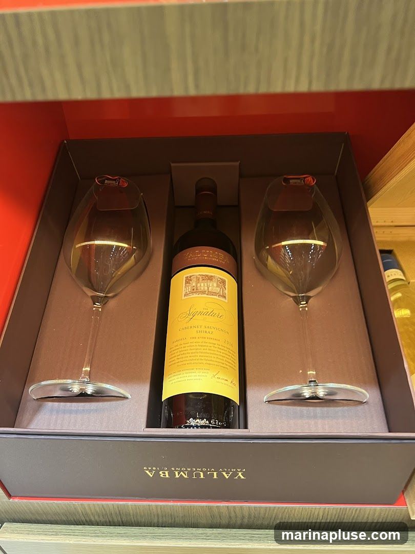 A gift box containing a bottle of Yalumba The Signature Cabernet Sauvignon Shiraz 2016 and two wine glasses. The box is red and grey, with the Yalumba logo visible on the bottom.