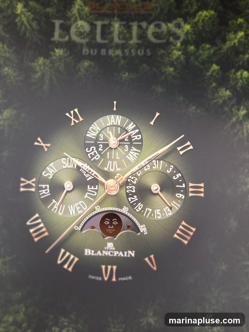 A close-up of a Blancpain watch face with a green dial. The watch features multiple complications, including a moon phase indicator with a face, day of the week, month, and date. Roman numerals are used for the hours. The background appears to be a dark forest scene.
