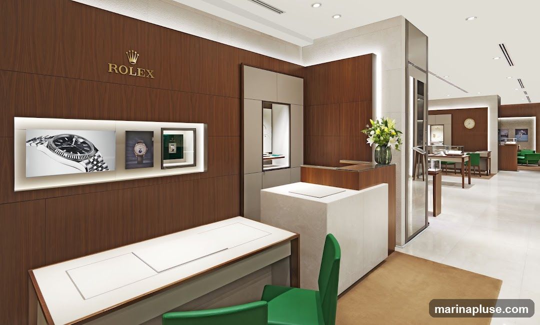 The interior of a luxurious Rolex watch store. The walls are paneled with dark wood, and the Rolex logo is prominently displayed in gold. There are display cases showcasing watches, and a reception desk. The store is well-lit and has a modern, elegant design.