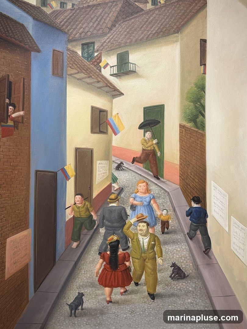 A painting depicting a narrow cobblestone street lined with buildings. Several people, including men, women, and children, are walking along the street. Some are carrying umbrellas, and there are also dogs present. Colombian flags are displayed from windows and on poles. Posters are affixed to the walls of some buildings. The style is somewhat surreal and stylized.