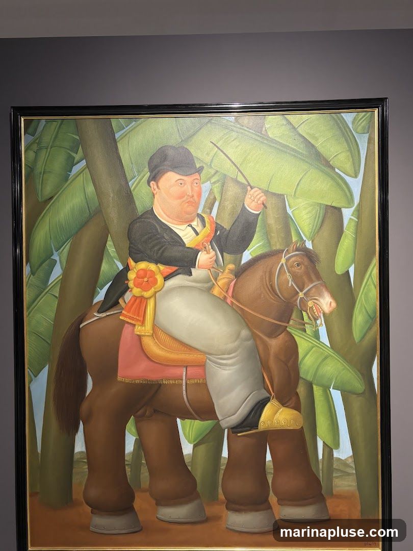 A painting depicts a portly man in a black hat and suit riding a brown horse. The man wears a sash and holds a riding crop. The background features large green leaves, suggesting a tropical setting. The painting is framed in black and gold.