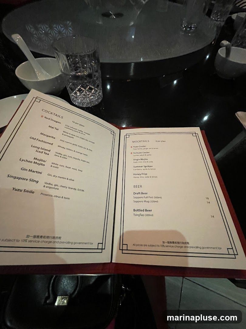 A menu open to a page listing cocktails, mocktails, and beer.