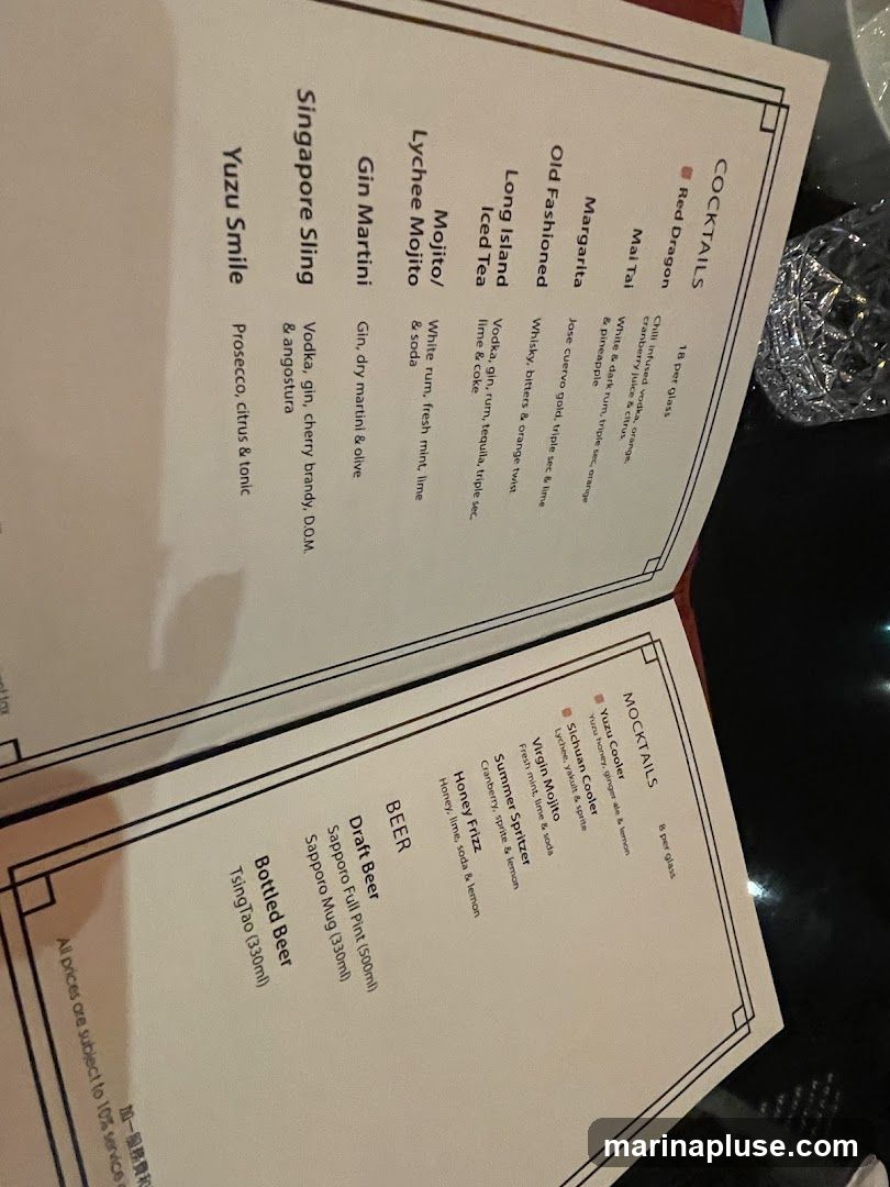A menu featuring cocktails, mocktails, and beer.