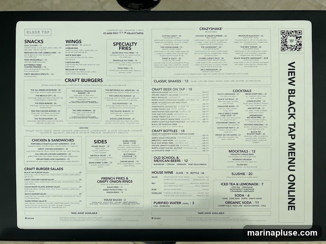 Menu for Black Tap featuring snacks, wings, specialty fries, craft burgers, chicken & sandwiches, sides, French fries & crispy onion rings, milkshakes, classic shakes, craft beer on tap, craft bottles, cocktails, mocktails, slushies, iced tea & lemonade, and sodas.