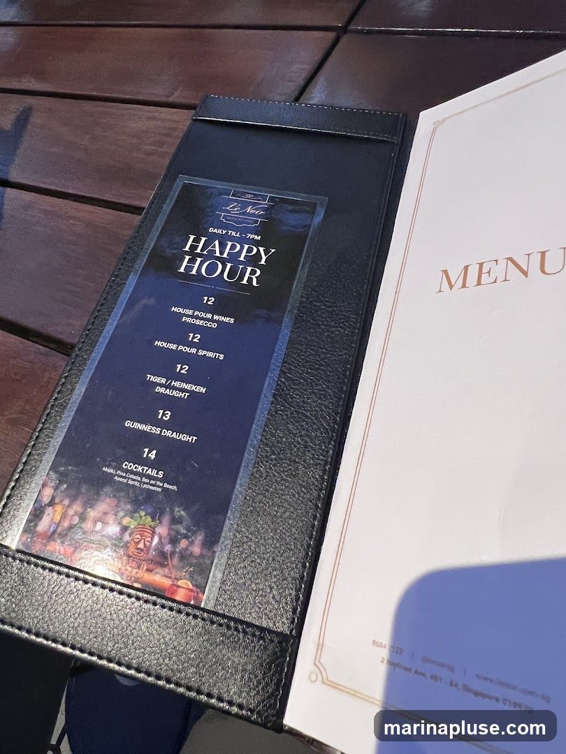 A menu for Le Noir featuring happy hour specials and cocktails.