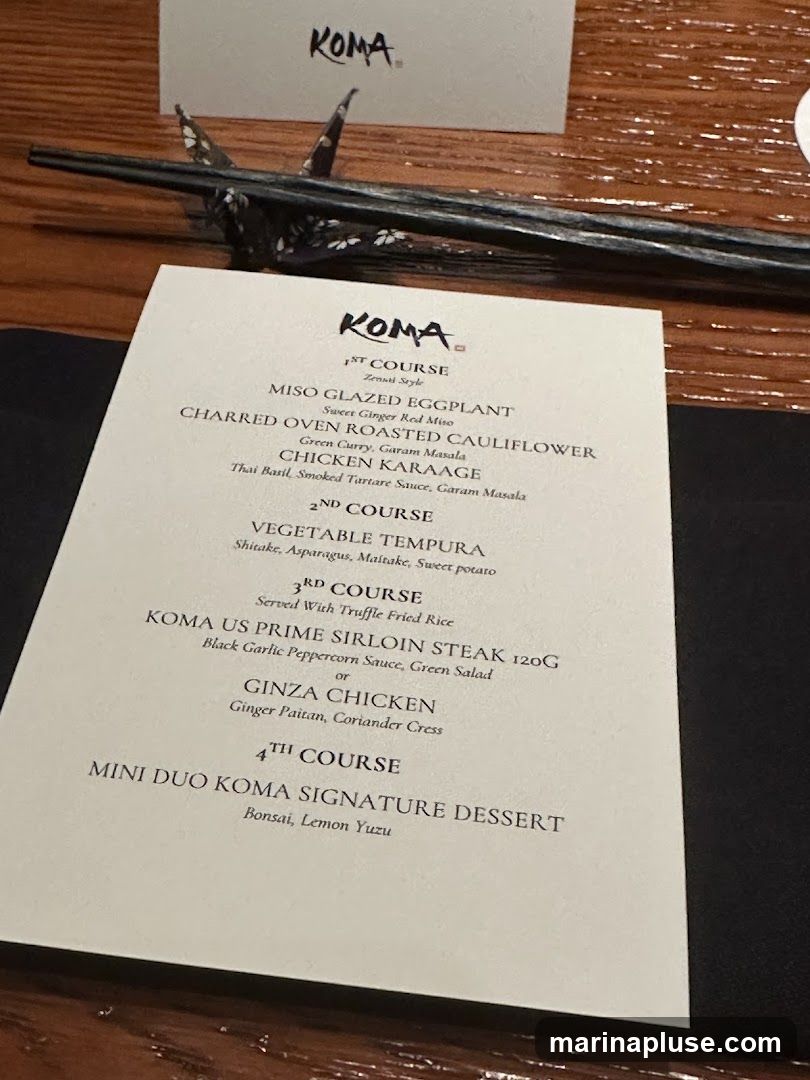 A menu from KOMA restaurant with a multi-course meal.