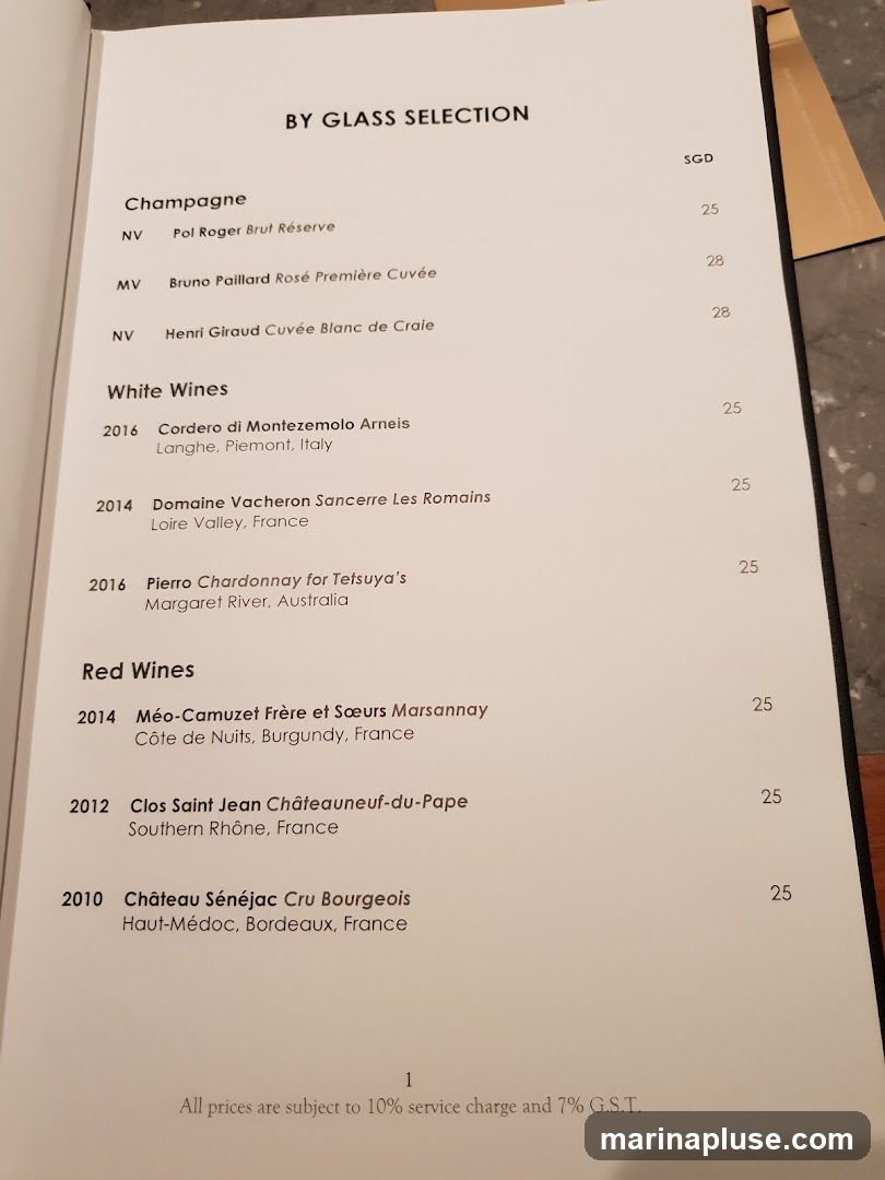 A menu listing wines available by the glass, with prices in SGD. Includes Champagne, White Wines, and Red Wines.