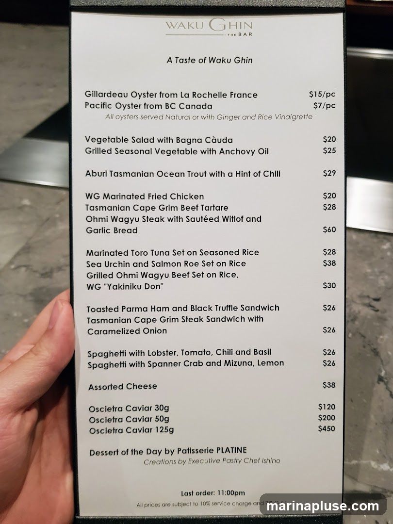 Menu from Waku Ghin The Bar with various seafood, meat, and other dishes.