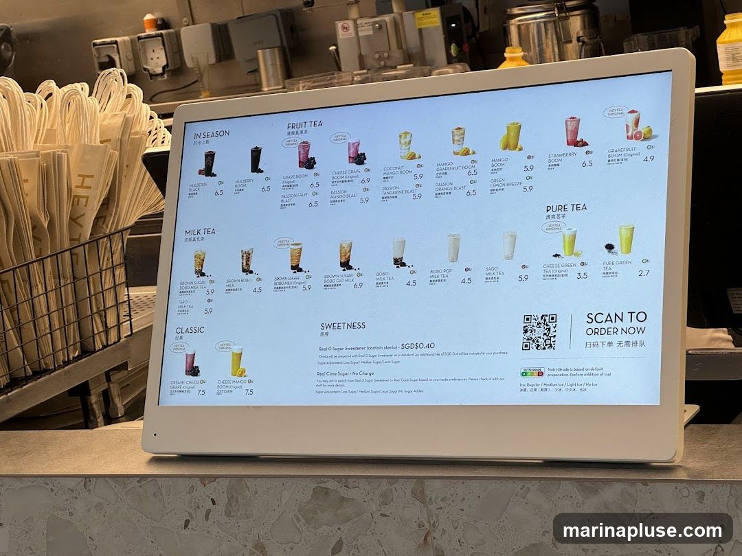 A digital menu displaying various fruit teas, milk teas, classic drinks, and pure teas. Options for sweetness levels and ice are also available.