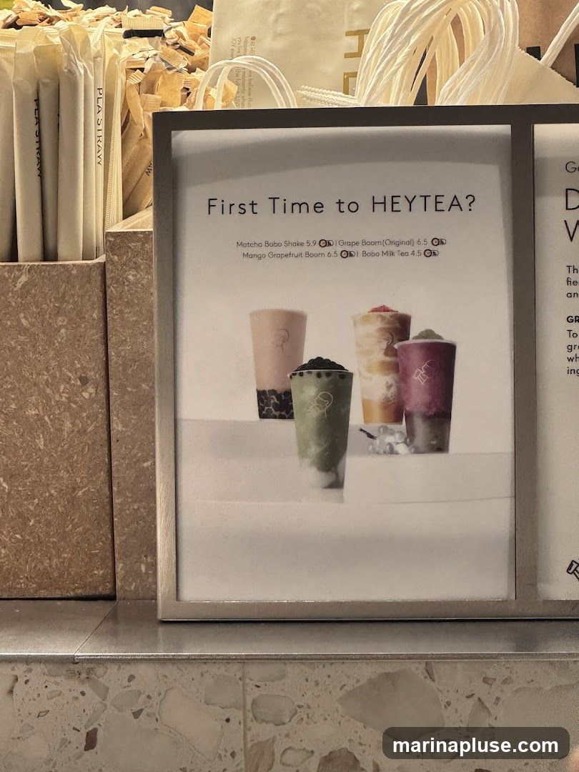 A menu board for HEYTEA, featuring popular drinks for first-time customers. The menu displays images of four different drinks and lists their names and prices.