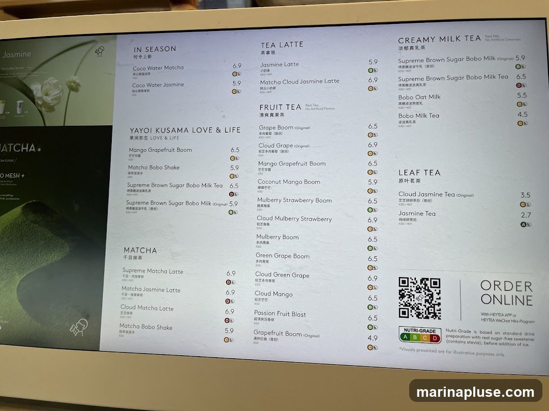 A digital menu displaying various tea and drink options categorized into IN SEASON, YAYOI KUSAMA LOVE & LIFE, MATCHA, TEA LATTE, FRUIT TEA, CREAMY MILK TEA, and LEAF TEA. Includes nutritional grades and an online ordering QR code.