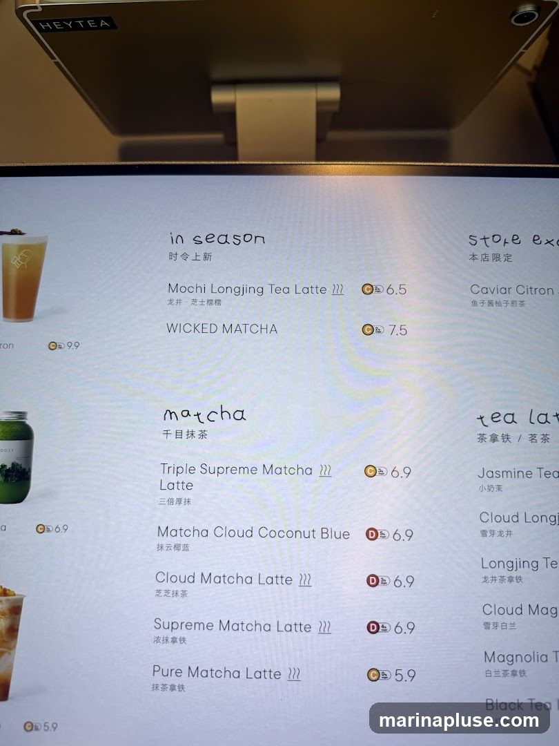 A digital menu displaying various tea lattes and other beverages.