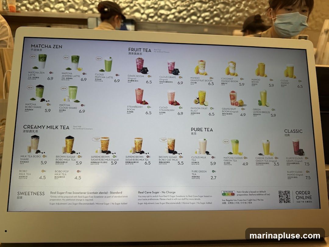 A digital menu displaying various tea options categorized into Matcha Zen, Fruit Tea, Creamy Milk Tea, Pure Tea, and Classic. Each item includes an image, name, and price. Sweetness and ice level options are also detailed at the bottom.