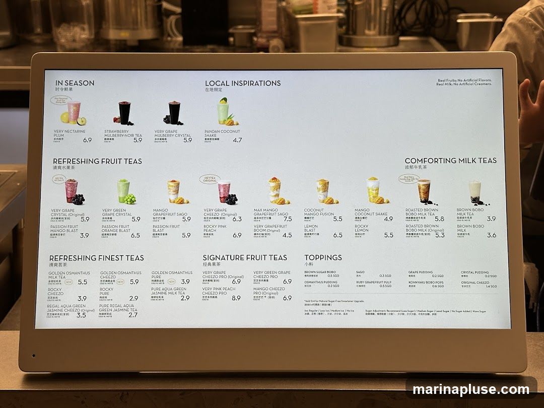 A digital menu displaying various drinks categorized into 'In Season', 'Local Inspirations', 'Refreshing Fruit Teas', 'Refreshing Finest Teas', 'Signature Fruit Teas', 'Comforting Milk Teas', and 'Toppings'. The menu features images of the drinks with their names and prices.