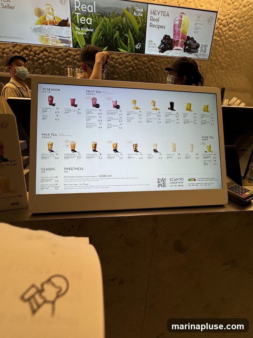 A digital menu displaying various tea options, including seasonal, fruit, milk, classic, and pure teas. Prices are listed in SGD.