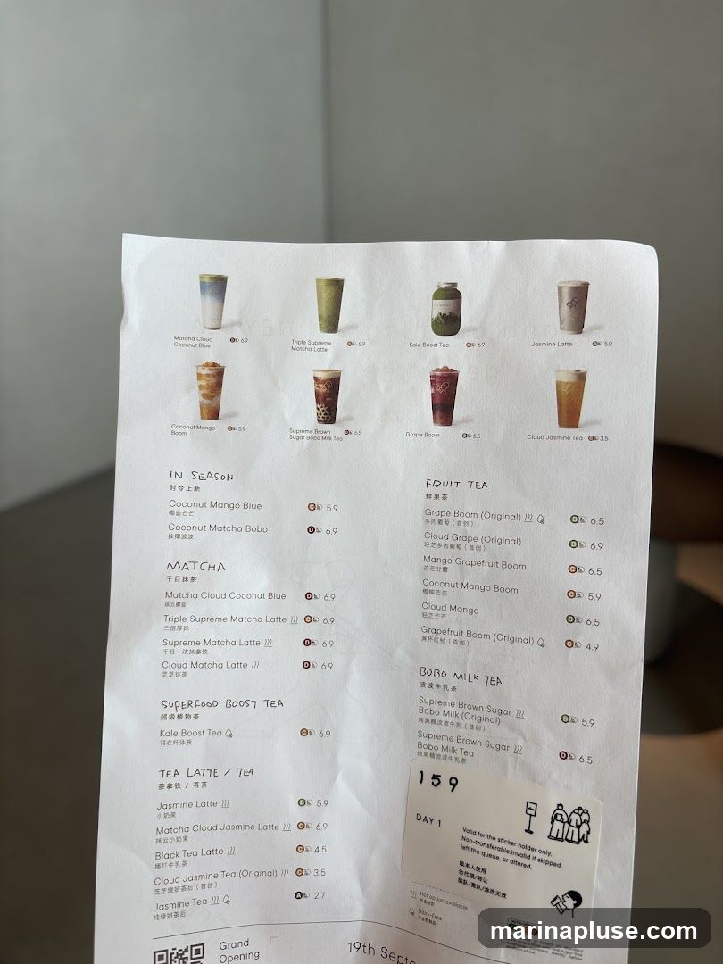 A menu with various tea and drink options, categorized into 'IN SEASON', 'MATCHA', 'SUPERFOOD BOOST TEA', 'TEA LATTE / TEA', 'FRUIT TEA', and 'BOBO MILK TEA'. Each item lists its name, and some have Chinese translations and prices. The menu also includes a sticker with 'DAY 1' and instructions in English and Chinese.