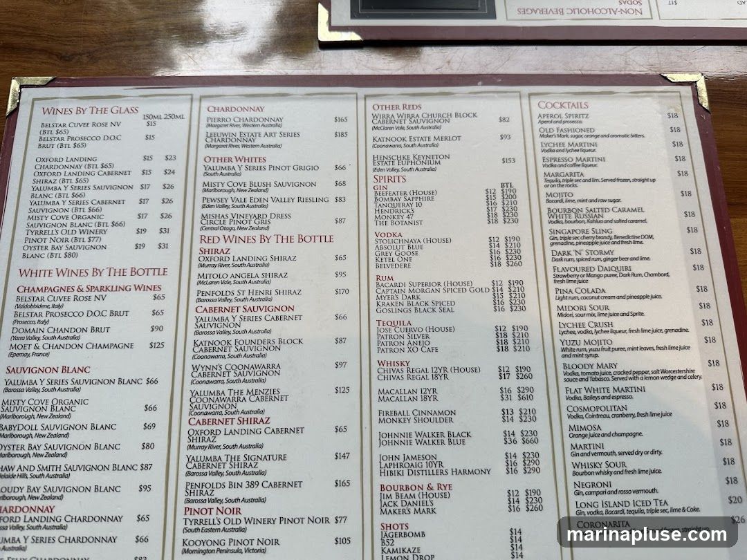 A menu featuring a wide selection of wines by the glass and bottle, including Chardonnay, Shiraz, Sauvignon Blanc, Pinot Noir, and sparkling wines. It also lists various cocktails, spirits, and other beverages.