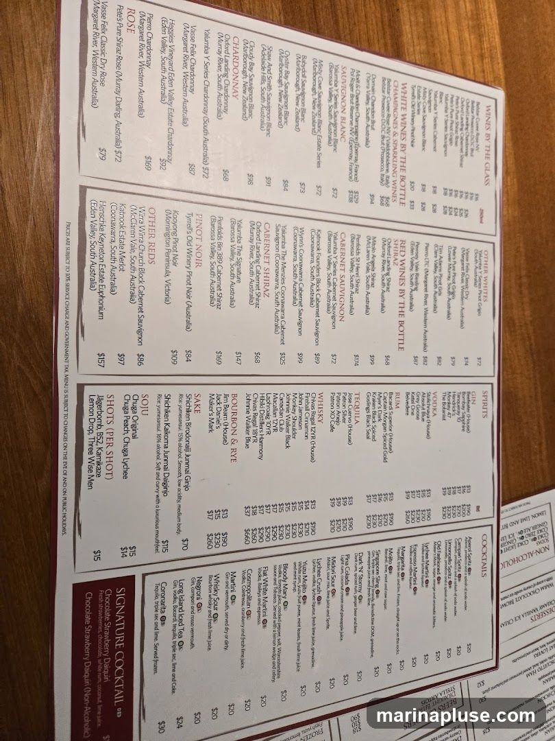 Menu with sections for wines, spirits, cocktails, non-alcoholic drinks, and desserts. Prices are listed for various beverages.