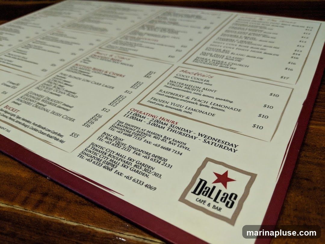 A menu from Dallas Cafe & Bar with sections for Bottled Beers & Ciders, Buckets, Mocktails, and Operating Hours.