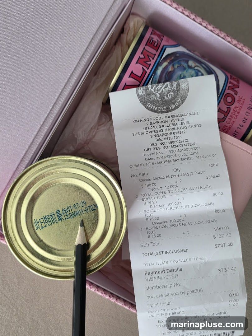 A receipt from Kim Hing Food at Marina Bay Sands is shown next to a can of abalone. The receipt details purchases of abalone and bird's nest products.