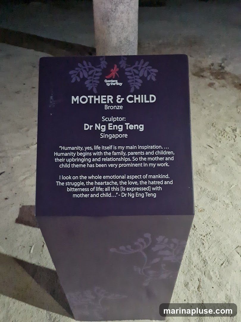 A purple informational plaque about a bronze sculpture titled "Mother & Child" by sculptor Dr Ng Eng Teng from Singapore. The plaque includes a quote from the artist about his inspiration. The Gardens by the Bay logo is visible at the top.