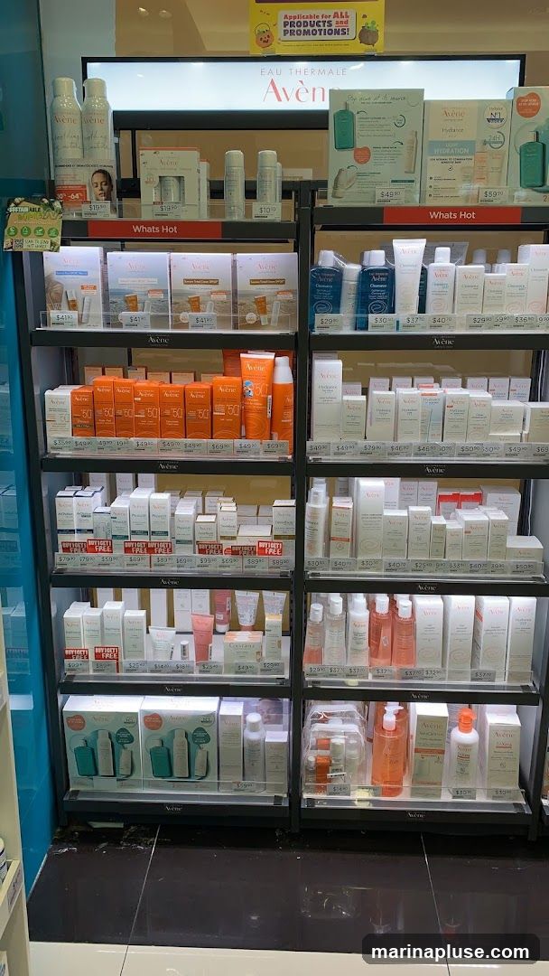A retail display featuring various Avene skincare products, including sunscreens, moisturizers, and cleansers. The shelves are organized with products and price tags. A promotional sign at the top reads "Applicable for ALL PRODUCTS and PROMOTIONS!".