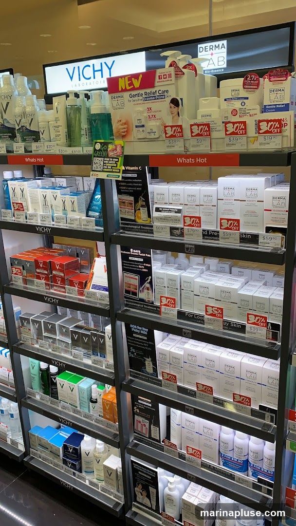 A retail display featuring various skincare products from Vichy and Derma Lab. The shelves are stocked with numerous bottles, boxes, and tubes of creams, lotions, and serums. Promotional signs indicating "30% OFF" and "Whats Hot" are visible throughout the display.
