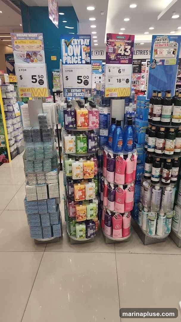 A display of various personal care products at a Watsons store. The display features promotional signs for "EVERYDAY LOW PRICE" and other offers. Products include body wash, soap, and other toiletries.