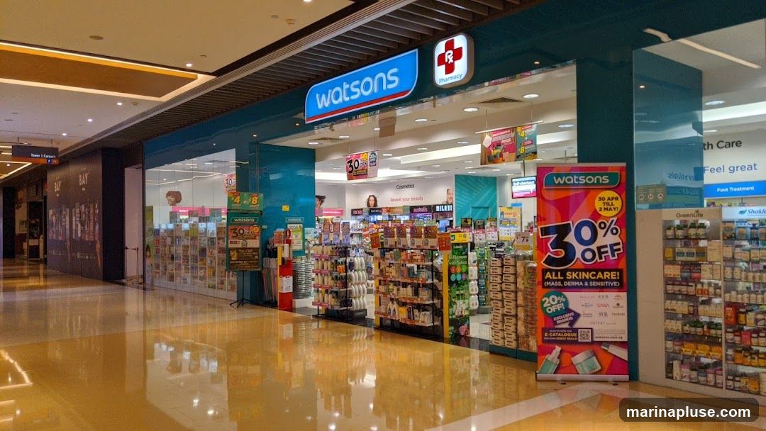 The exterior of a Watsons pharmacy with its prominent signage. The store is well-stocked with various health and beauty products displayed on shelves. A large promotional banner announces a 30% off sale on all skincare.