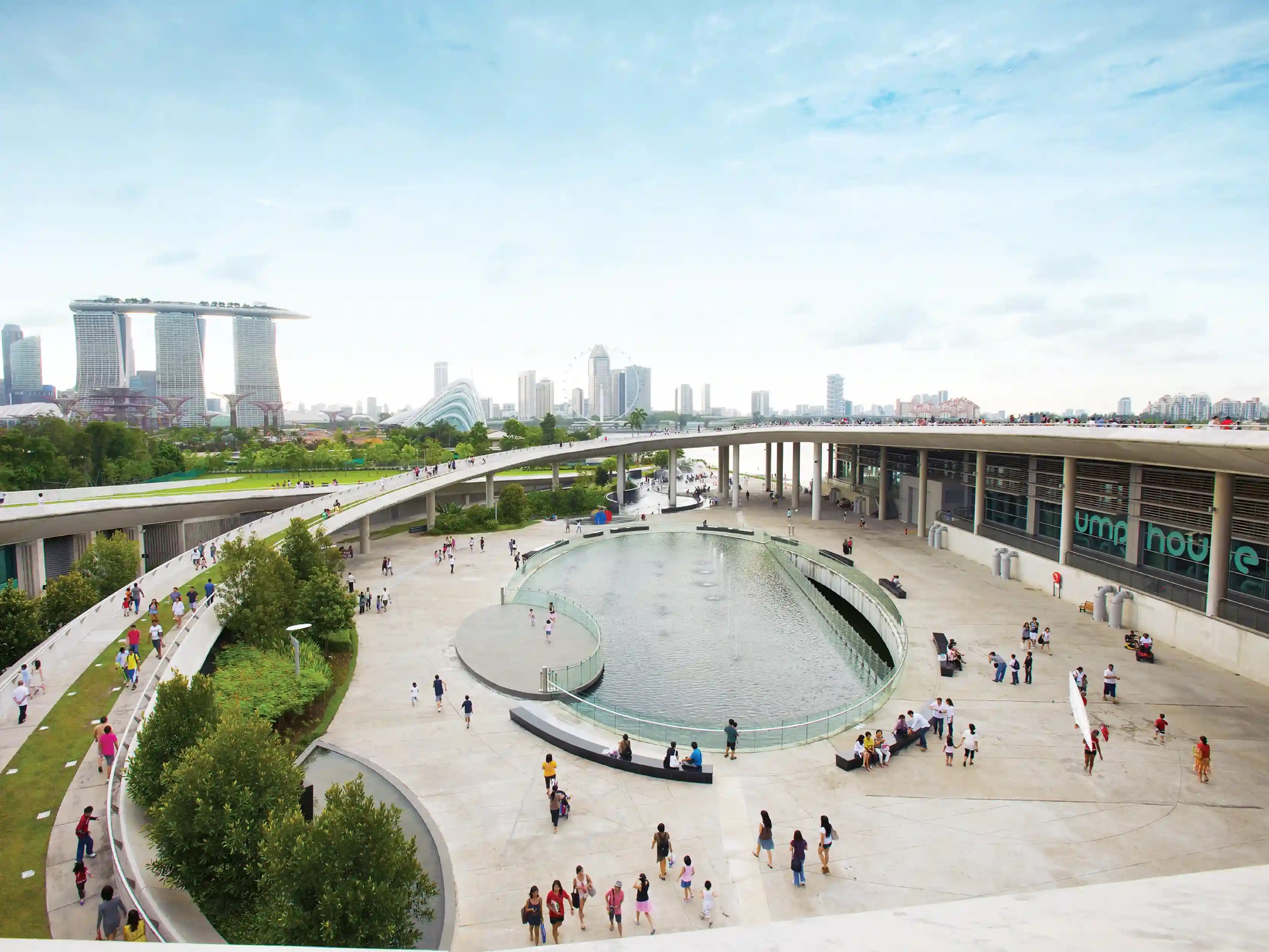 Marina Barrage central courtyard and Green Roof ramps with Marina Bay Sands across the reservoir