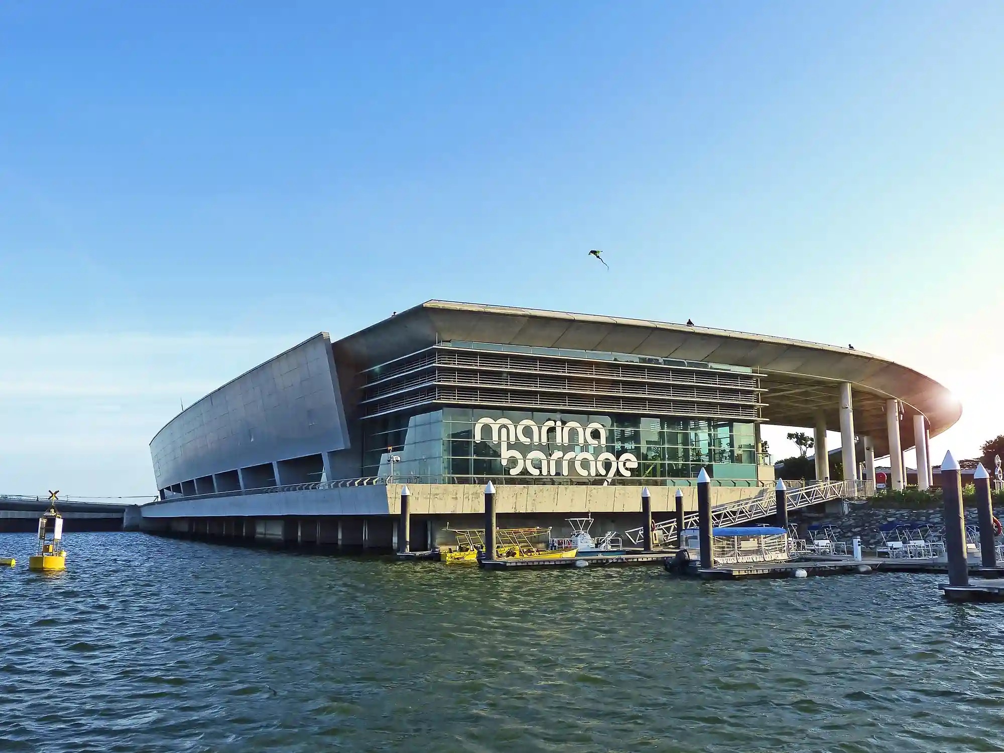 Marina Barrage building seen from Marina Reservoir with the marina barrage sign on the glass facade